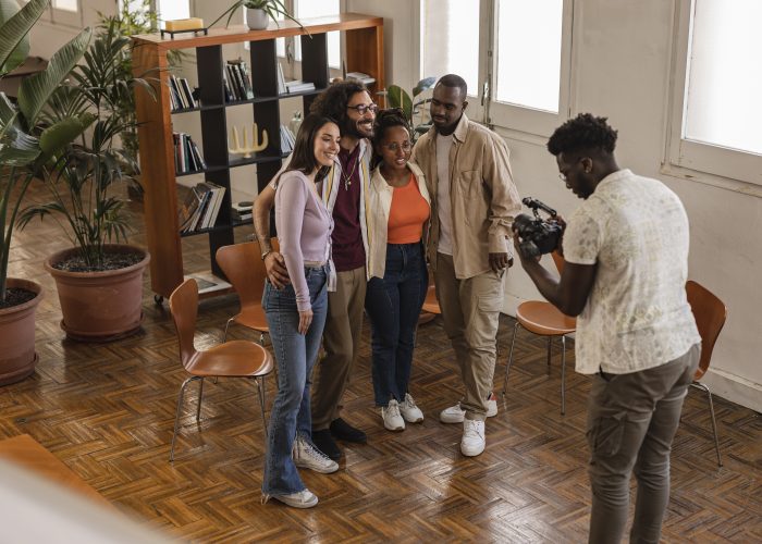 group of diverse workers in coworking, they are shooting a promotional video photographer videographer blog